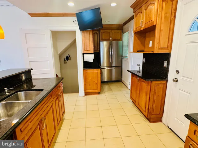 a kitchen with stainless steel appliances a sink and a refrigerator