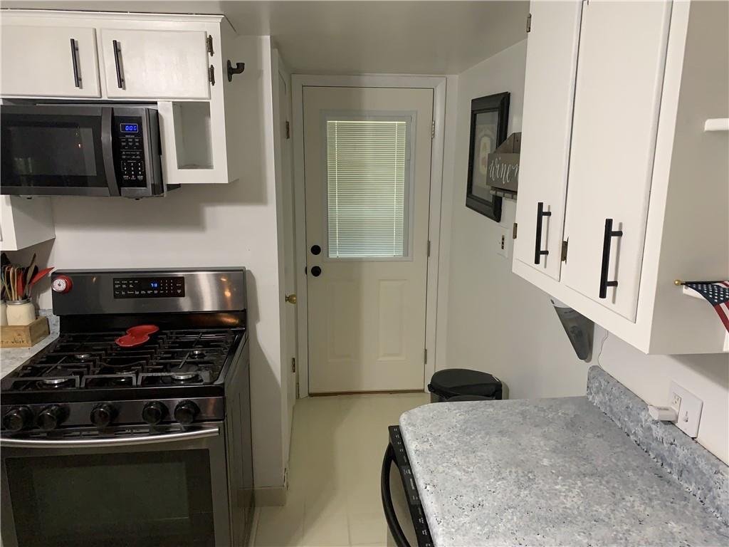 108 Wise Road Butler, PA 16002 - Photo 9 of 25 a kitchen with stainless steel appliances granite countertop a stove and a microwave