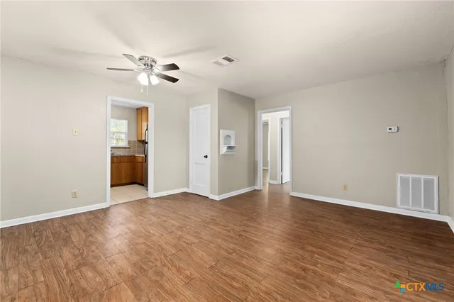 wooden floor in an empty room with a window