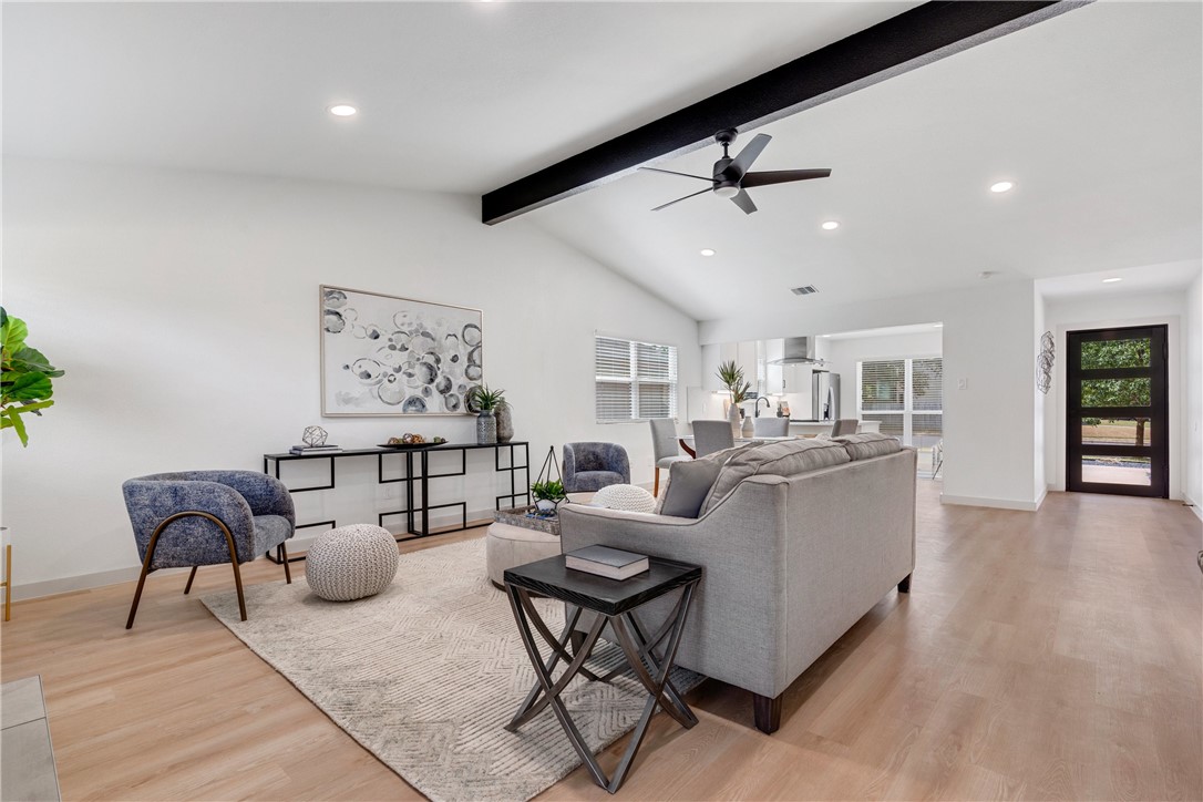 a living room with furniture and a wooden floor