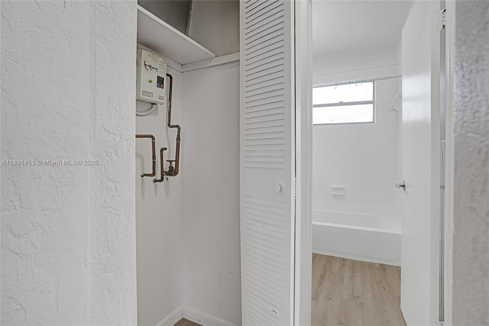 14100 Northwest 24th Court, Unit 303 Opa-Locka, FL 33054 - Photo 15 of 21 a bathroom with a shower