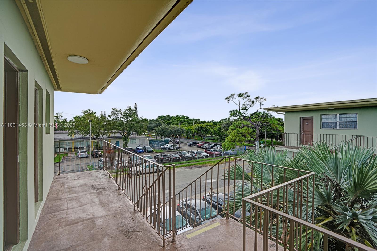 14100 Northwest 24th Court, Unit 303 Opa-Locka, FL 33054 - Photo 19 of 21 a view of a balcony with potted plants