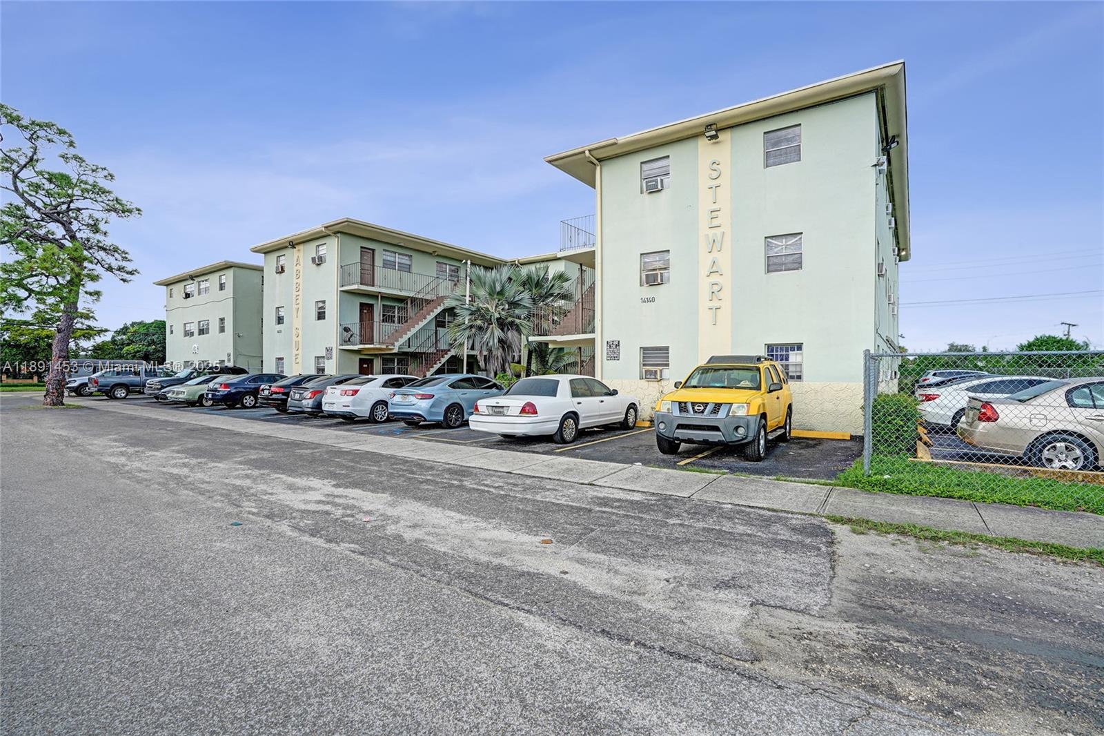 14100 Northwest 24th Court, Unit 303 Opa-Locka, FL 33054 - Photo 20 of 21 a view of a cars parked in front of a house