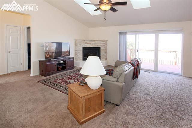 11720 Denver Road Peyton, CO 80831 - Photo 6 of 11 Living room with gas fireplace