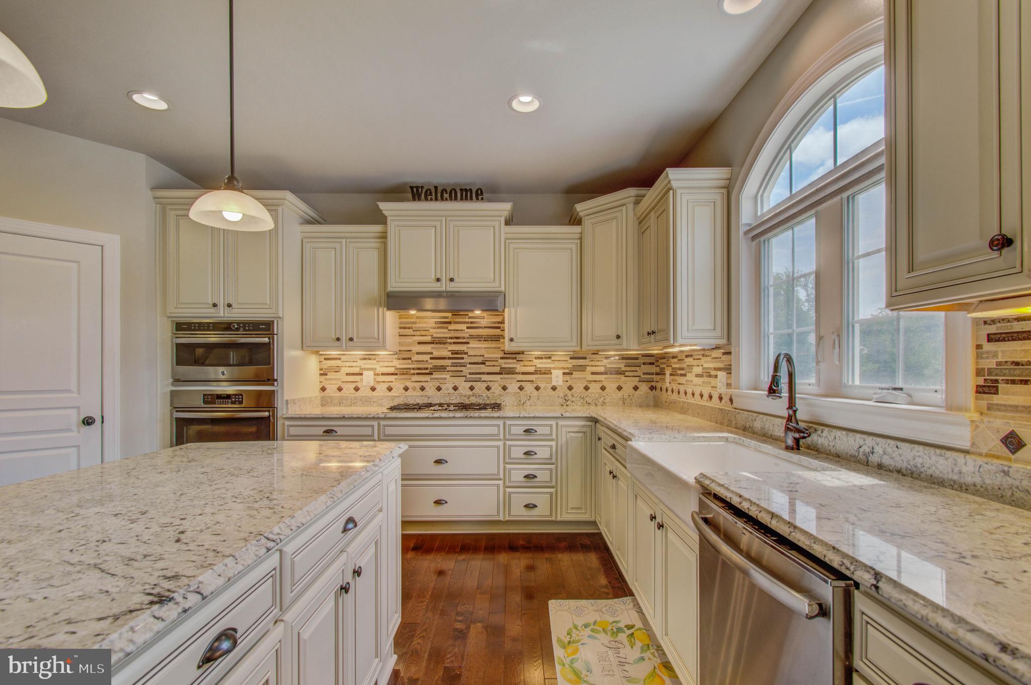 3188 Huntsman Drive Huntingtown, MD 20639 - Photo 15 of 98 a kitchen with stainless steel appliances granite countertop a sink stove and cabinets