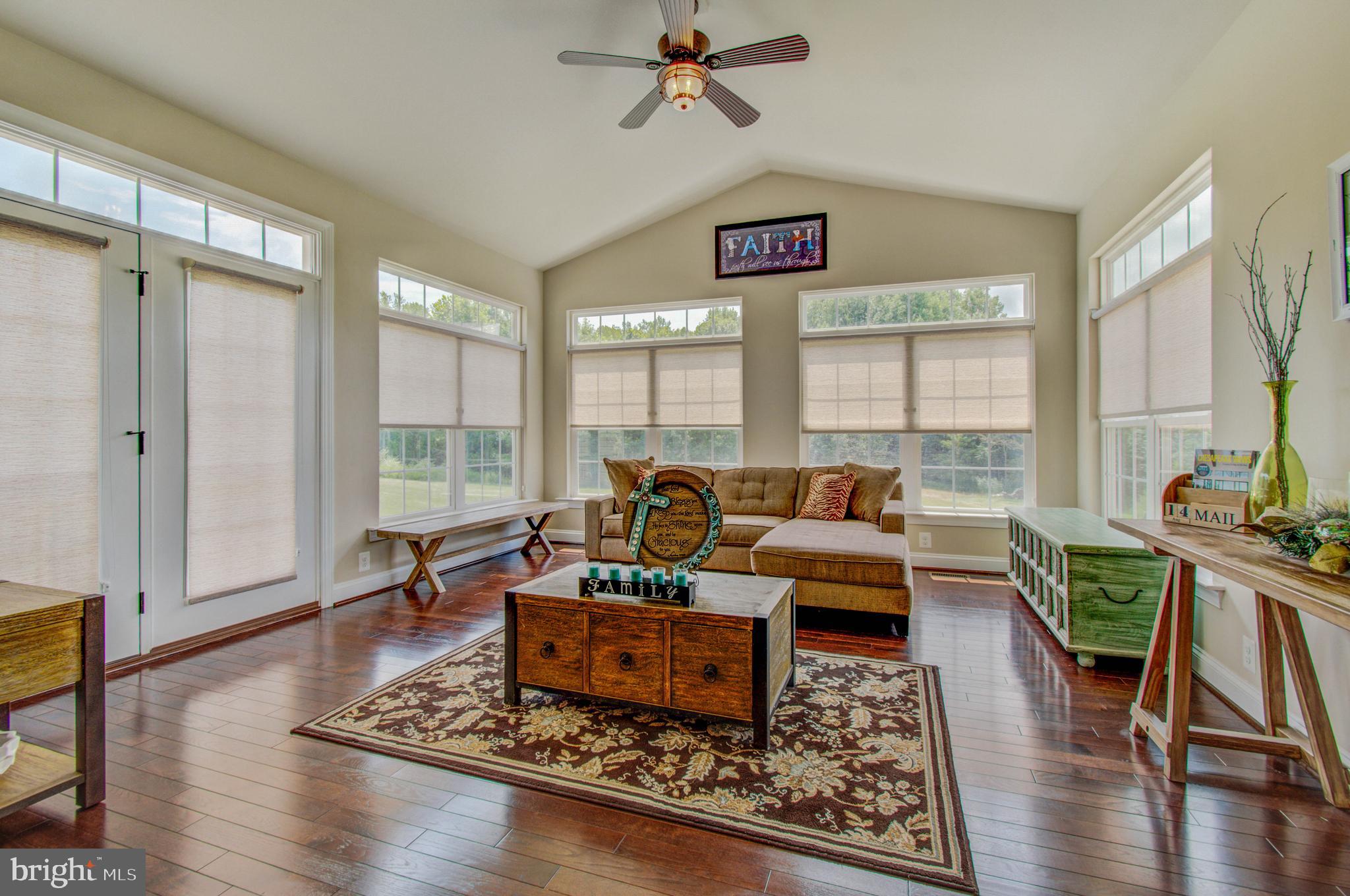 3188 Huntsman Drive Huntingtown, MD 20639 - Photo 21 of 98 a living room with furniture large window and wooden floor