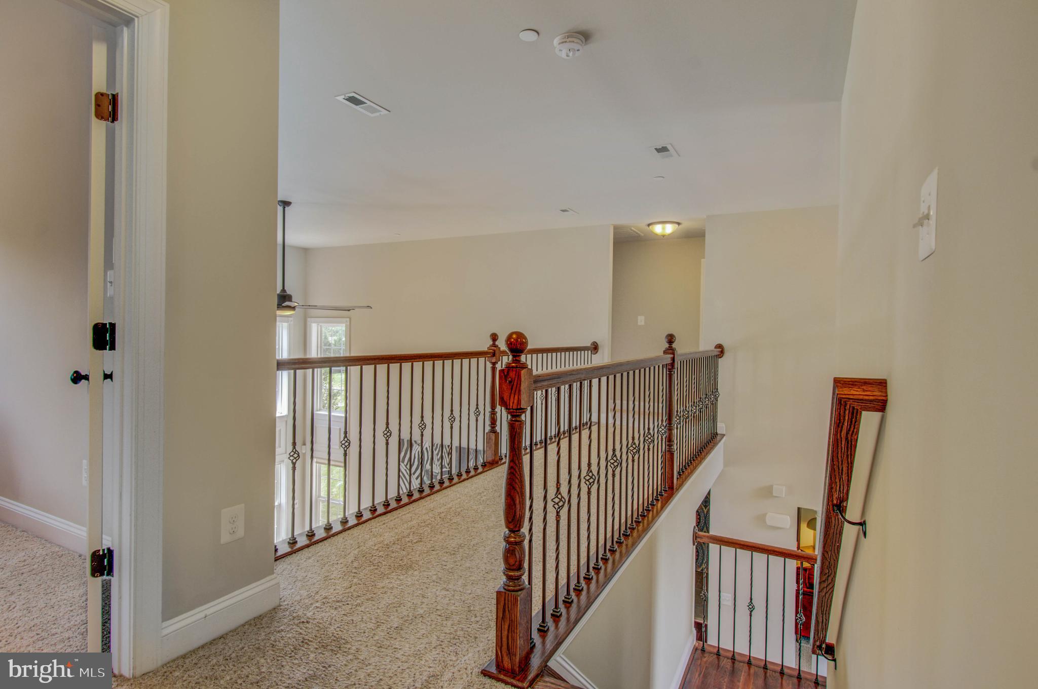 3188 Huntsman Drive Huntingtown, MD 20639 - Photo 30 of 98 a view of a hallway with wooden floor and windows