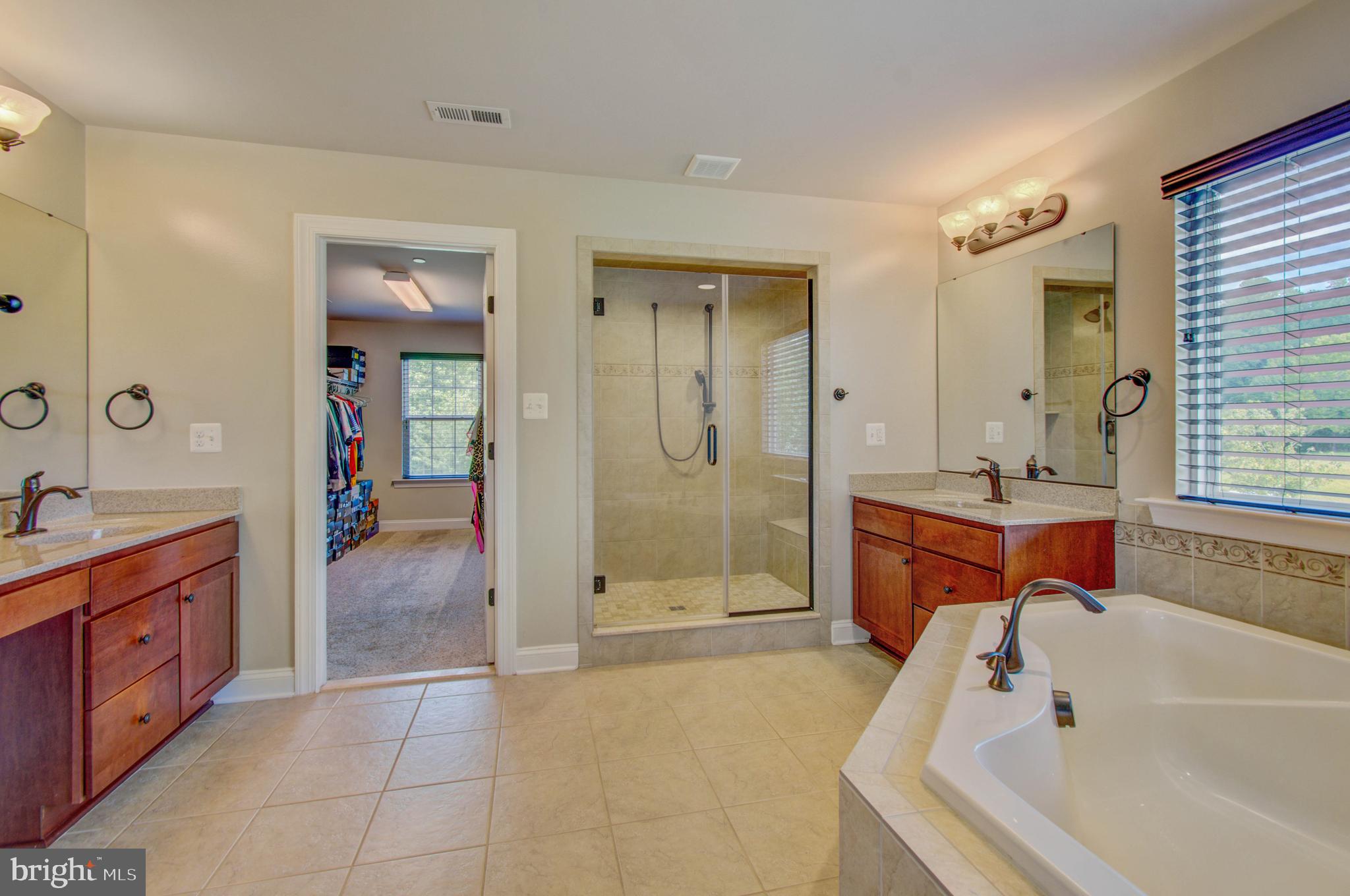 3188 Huntsman Drive Huntingtown, MD 20639 - Photo 36 of 98 a spacious bathroom with a tub sink shower and mirror
