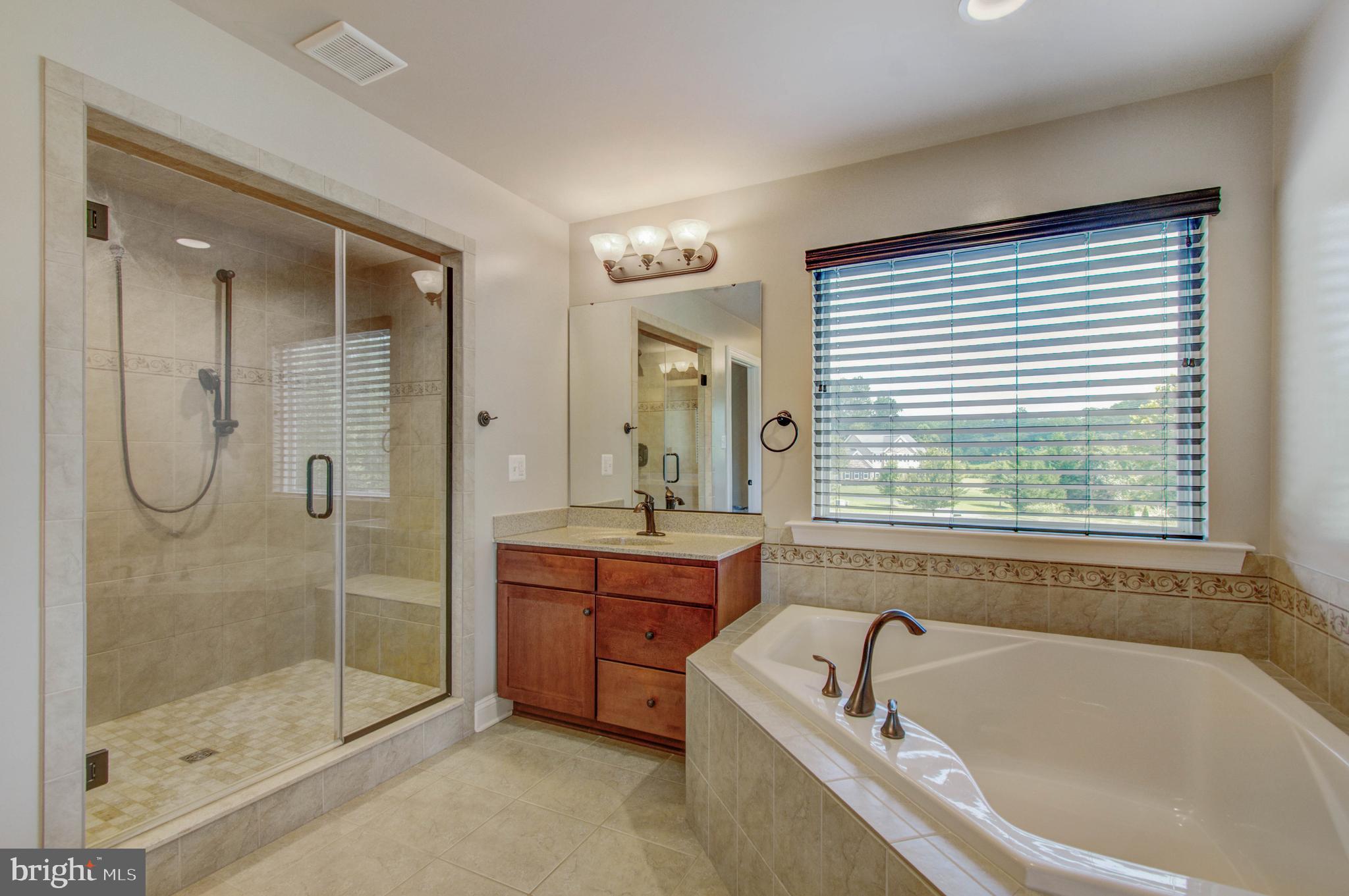 3188 Huntsman Drive Huntingtown, MD 20639 - Photo 37 of 98 a bathroom with a granite countertop tub a sink and a shower
