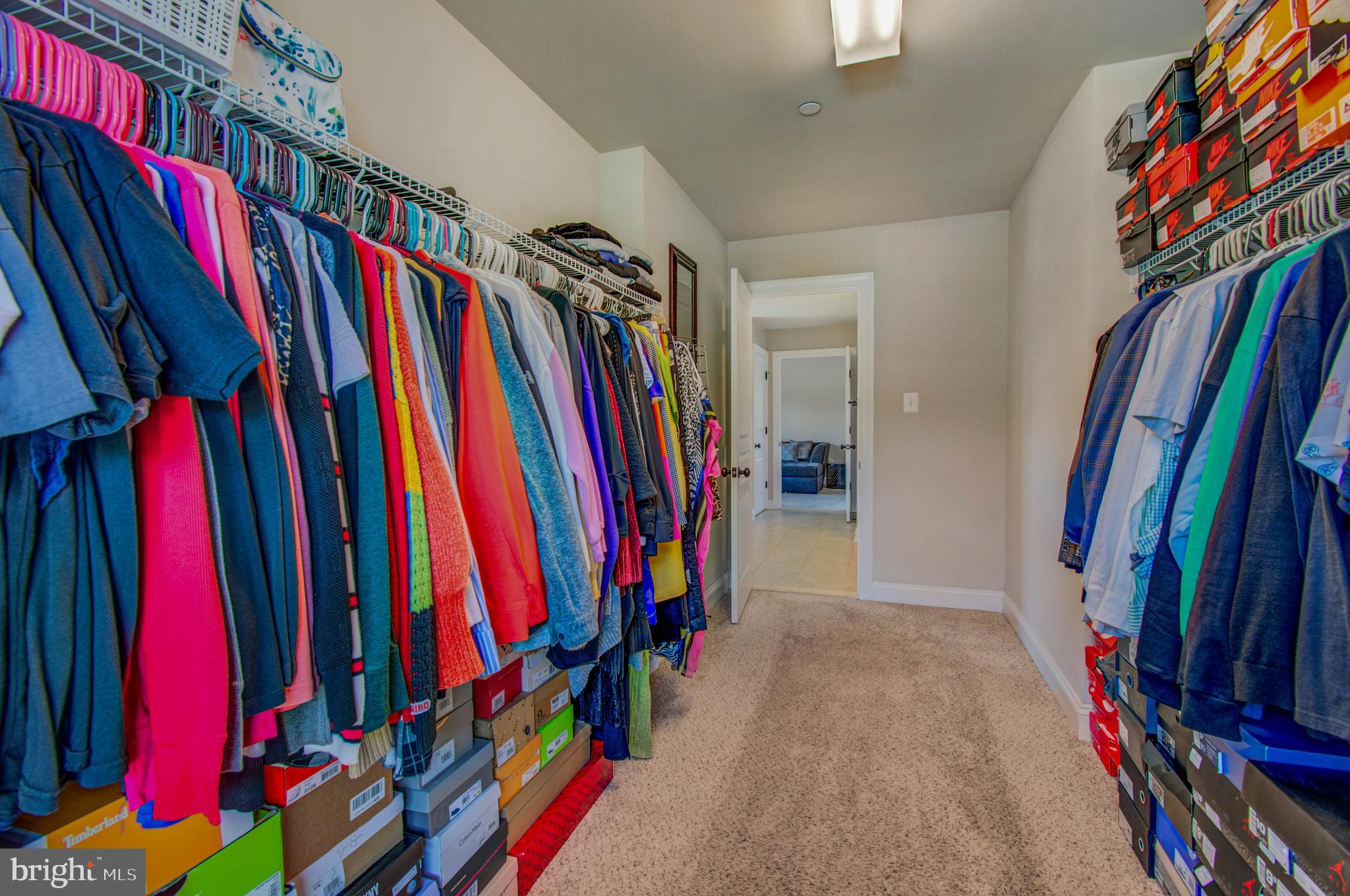 3188 Huntsman Drive Huntingtown, MD 20639 - Photo 40 of 98 a view of walk in closet with clothes and shoes