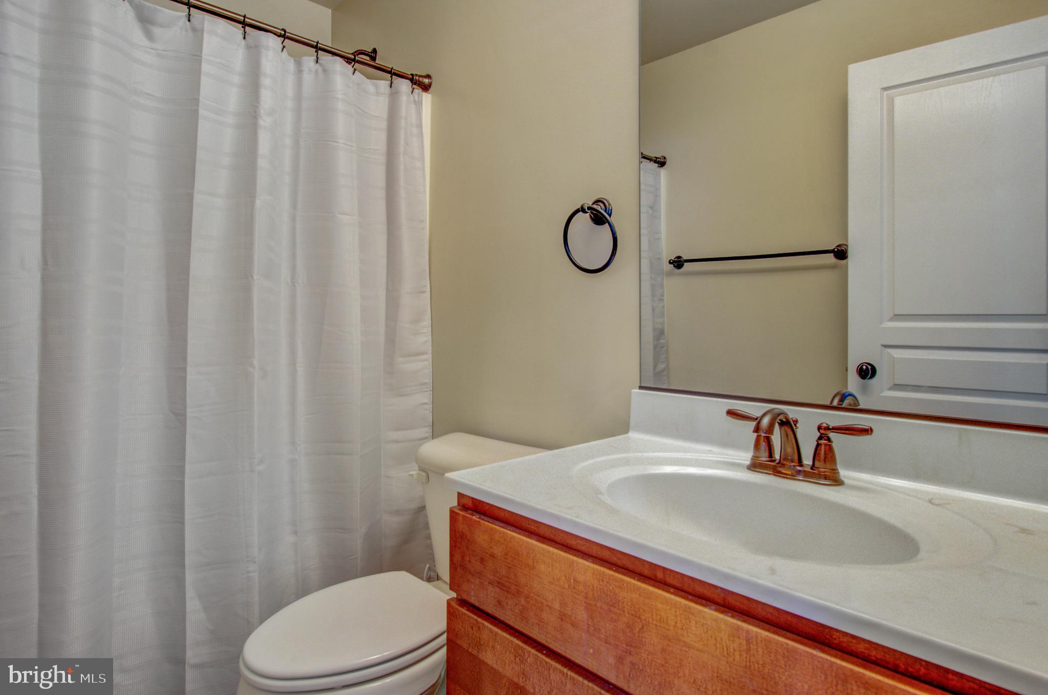 3188 Huntsman Drive Huntingtown, MD 20639 - Photo 47 of 98 a bathroom with a sink and a mirror