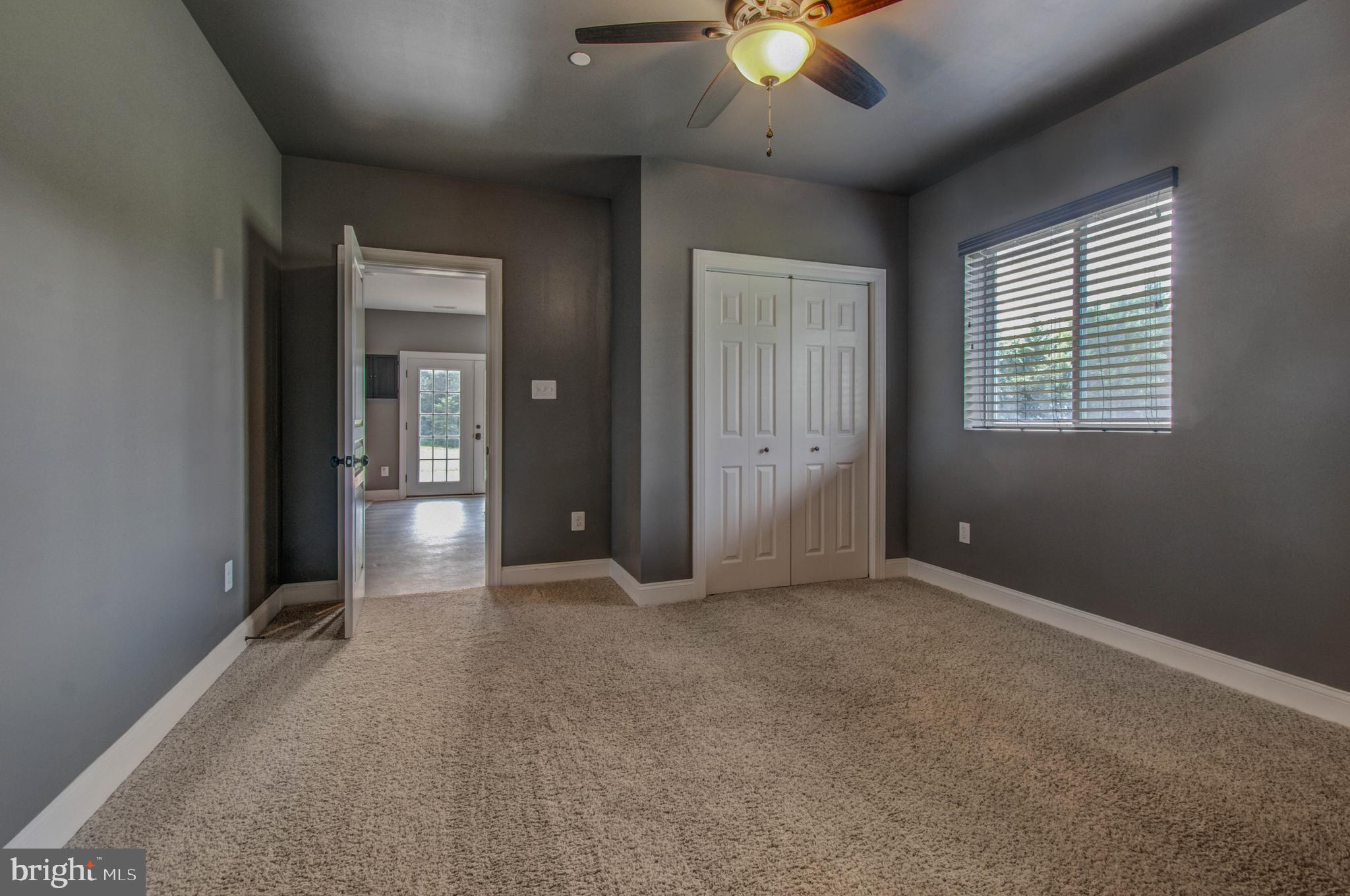 3188 Huntsman Drive Huntingtown, MD 20639 - Photo 63 of 98 an empty room with chandelier fan and windows