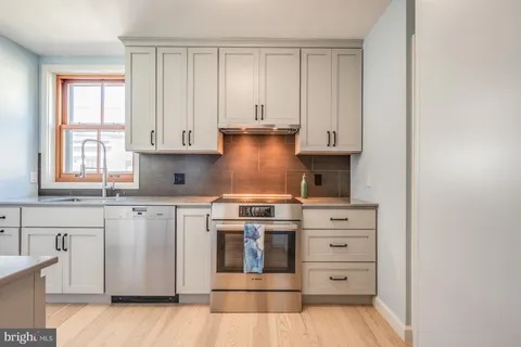 a kitchen with a sink stove and cabinets