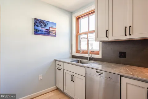 a kitchen with a sink and a stove