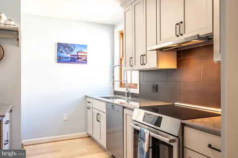 a kitchen with a stove and a sink
