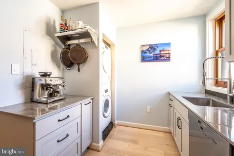 a kitchen with stainless steel appliances granite countertop a sink a stove and a refrigerator