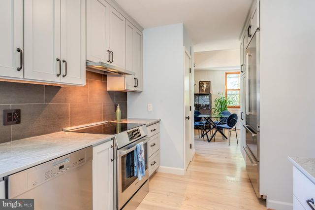 a kitchen with stainless steel appliances granite countertop a refrigerator and a stove