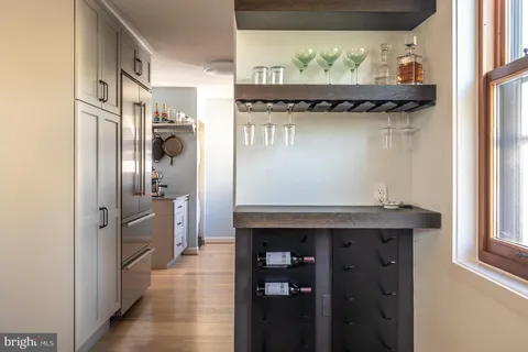 a living room with furniture a wooden floor and a large window
