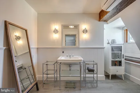 a view of a balcony with wooden floor and outdoor seating
