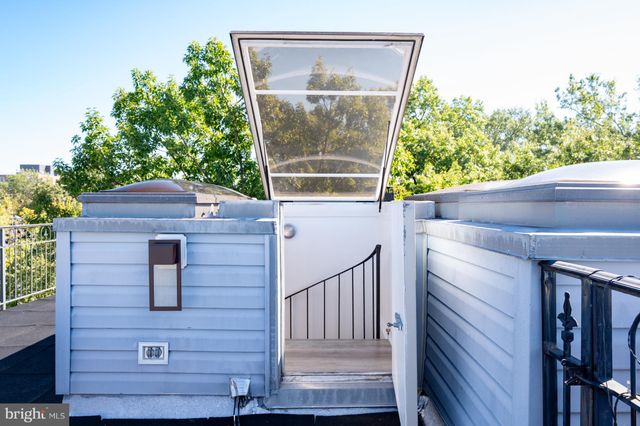 a view of a balcony with two chairs and a potted plant