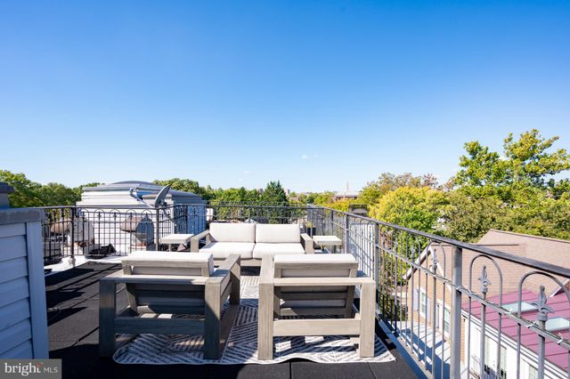 a view of a tables and chairs in the roof deck