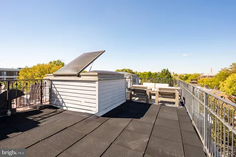 a view of a patio with table and chairs potted plants