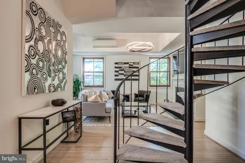 a kitchen with stainless steel appliances granite countertop a stove and white cabinets