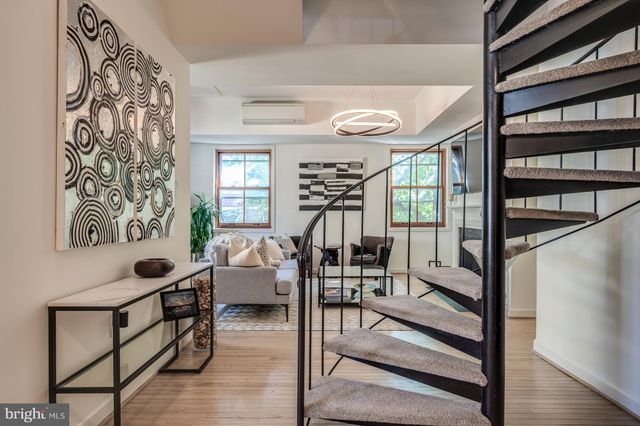 a kitchen with stainless steel appliances granite countertop a stove and white cabinets