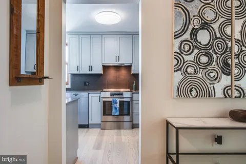 a kitchen with granite countertop white cabinets and window