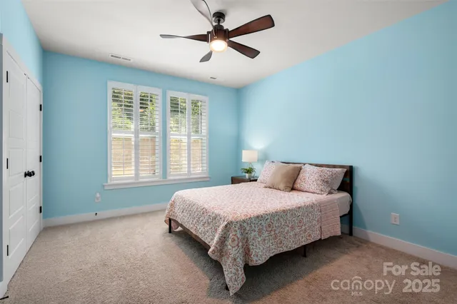 a bedroom with a bed and a lamp