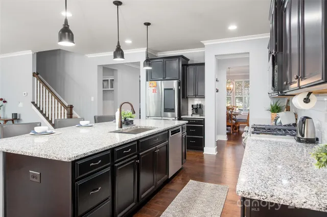a kitchen with granite countertop a stove and a sink