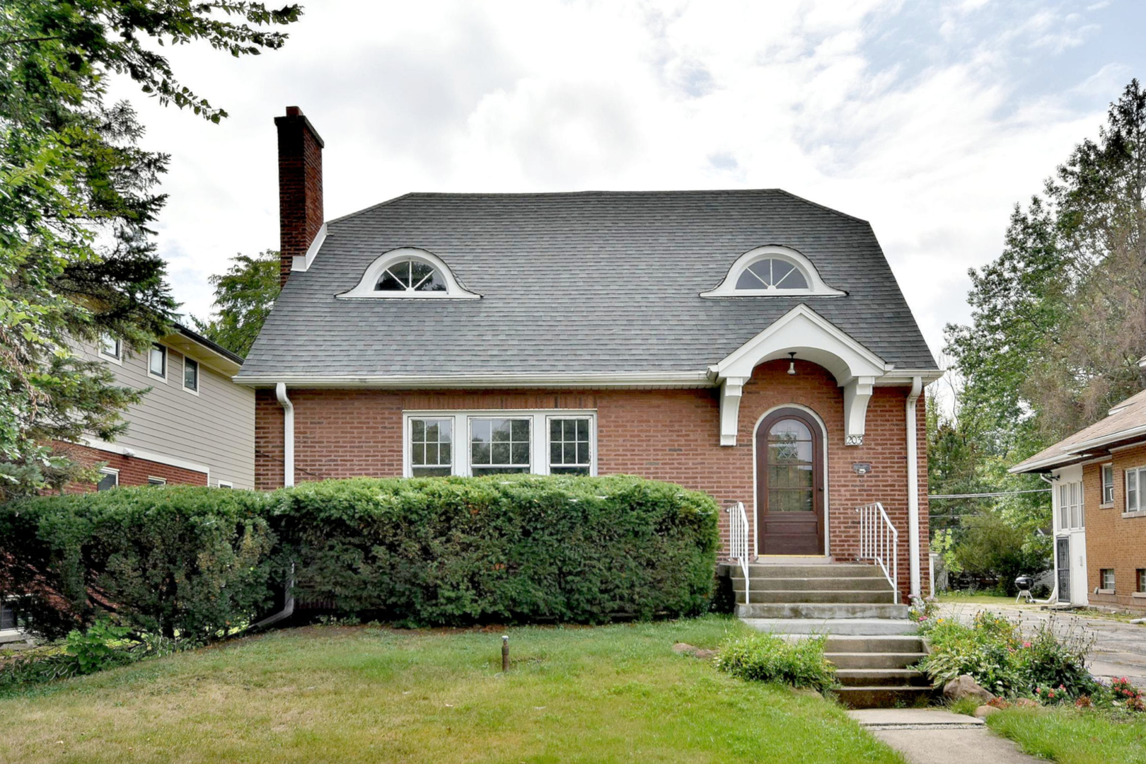 a front view of a house with garden