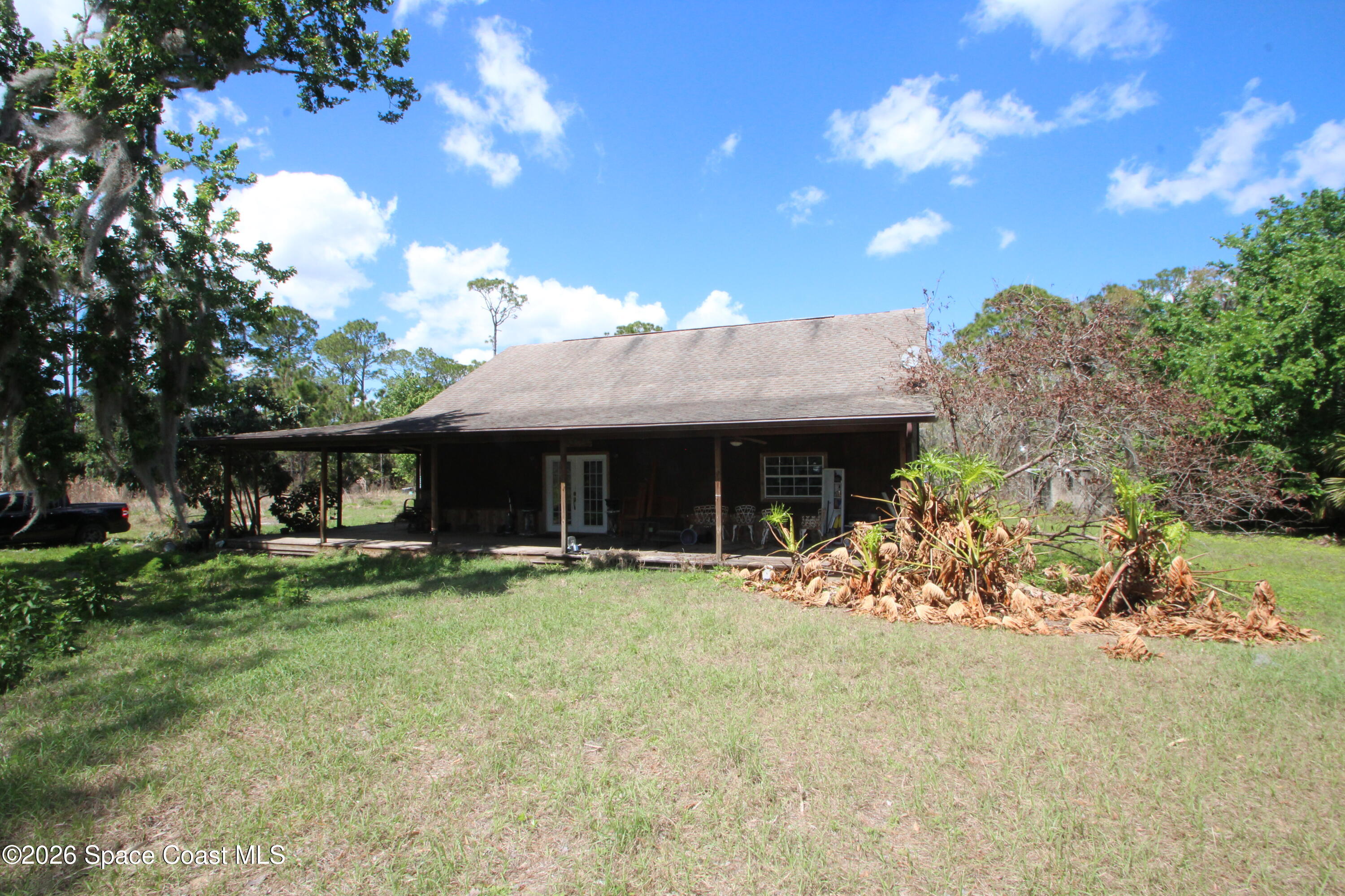 a view of a house with a yard and sitting area
