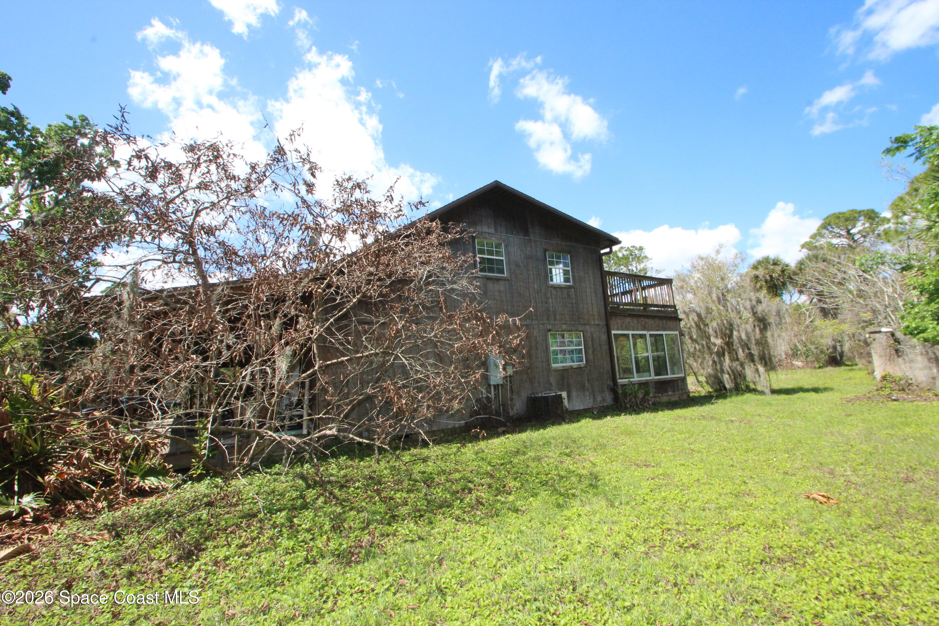 6480 Highway 46 Mims, FL 32754 - Photo 4 of 29 a view of a yard in front of a house with a large tree
