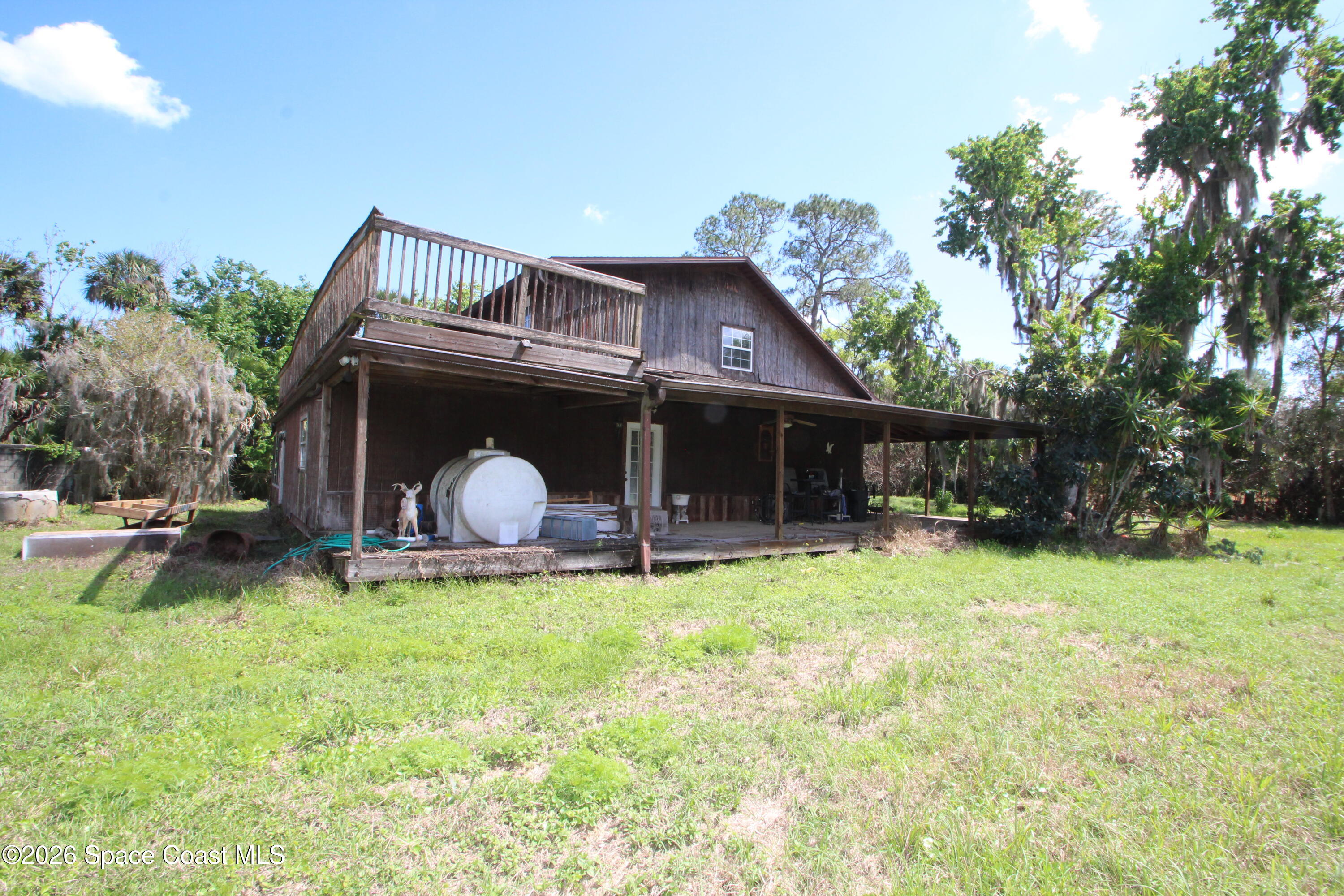 6480 Highway 46 Mims, FL 32754 - Photo 6 of 29 a view of a chair and table in backyard of the house