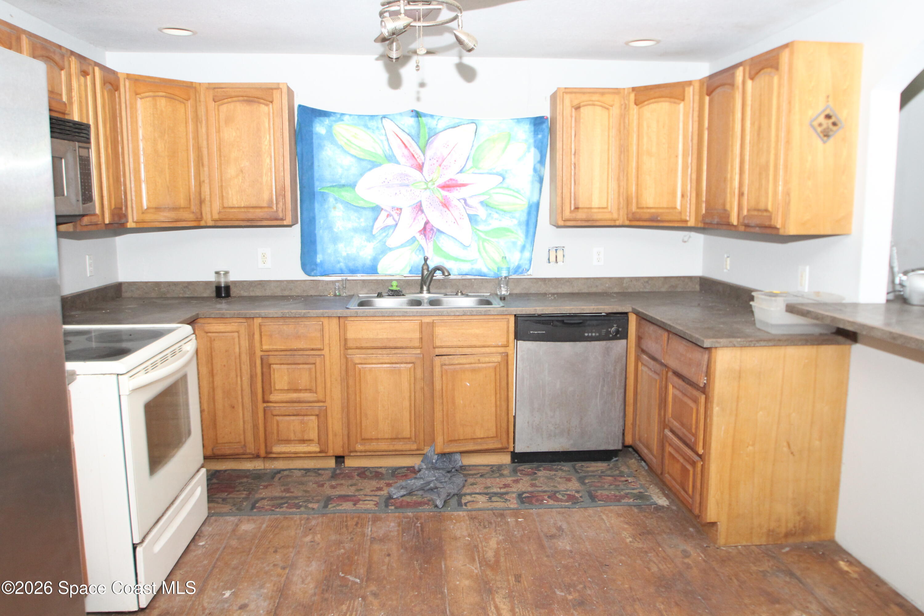 6480 Highway 46 Mims, FL 32754 - Photo 8 of 29 a kitchen with a sink stove and cabinets