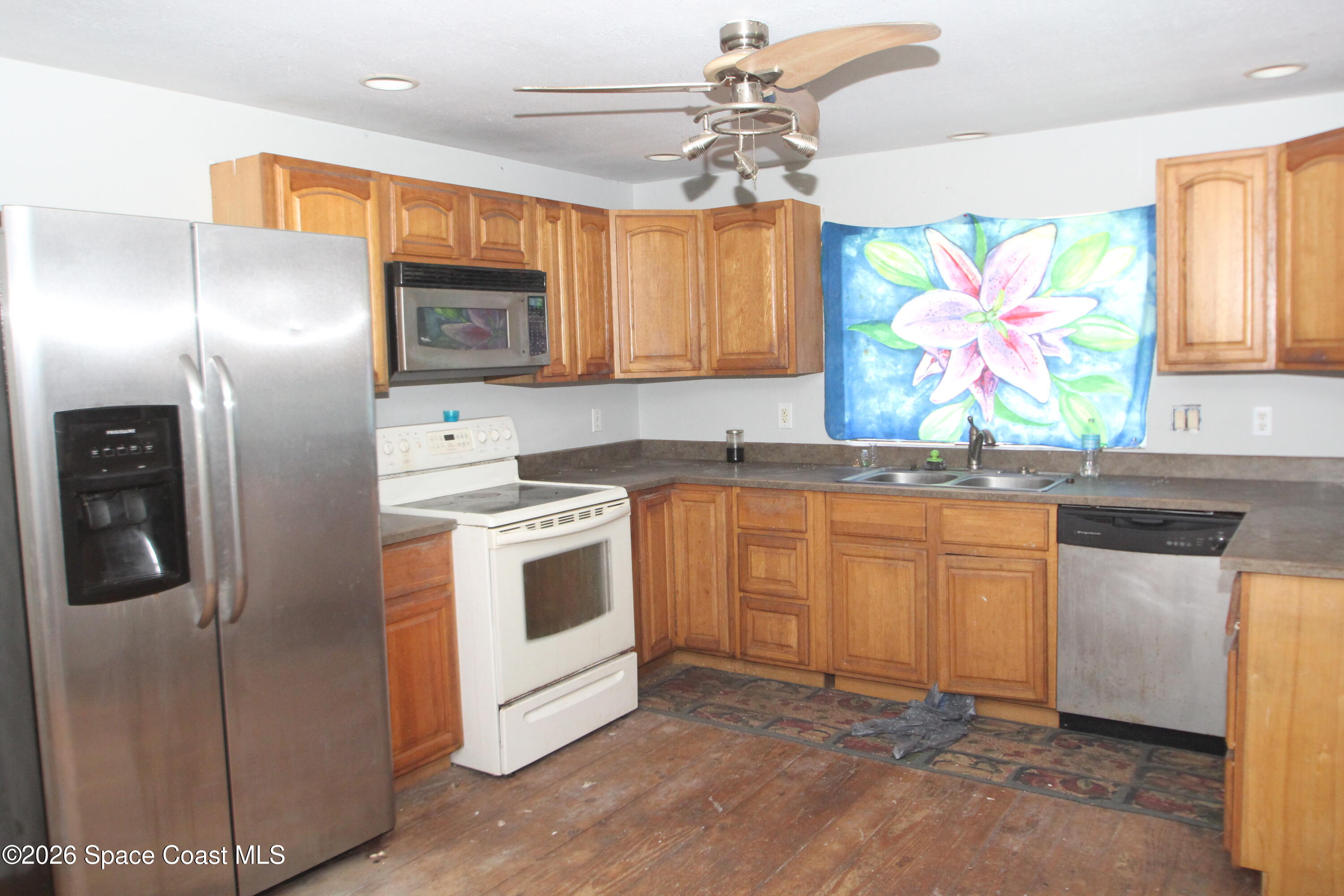 6480 Highway 46 Mims, FL 32754 - Photo 9 of 29 a kitchen with stainless steel appliances granite countertop a stove a sink and a refrigerator