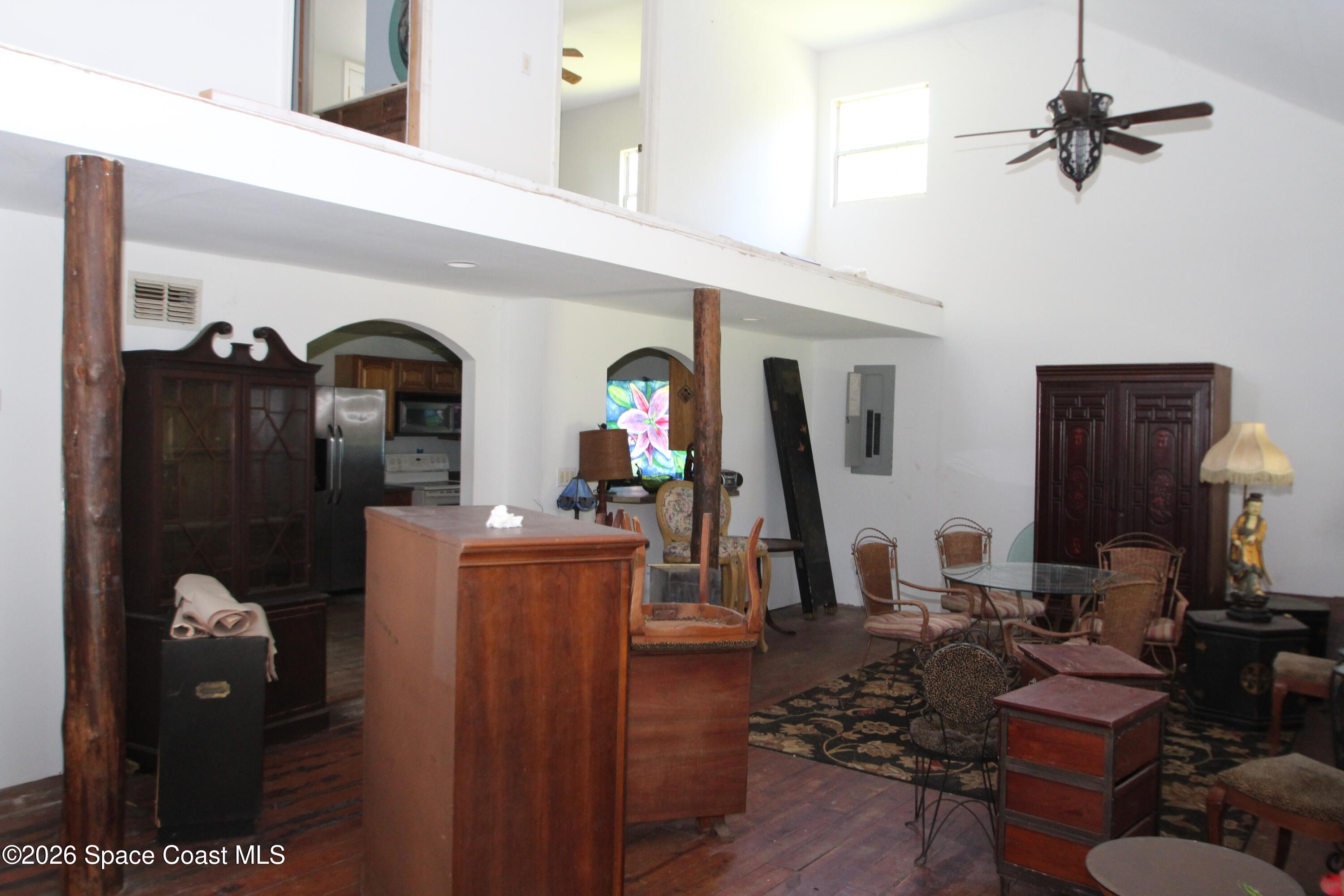 6480 Highway 46 Mims, FL 32754 - Photo 10 of 29 a living room with furniture a flat screen tv and a chandelier