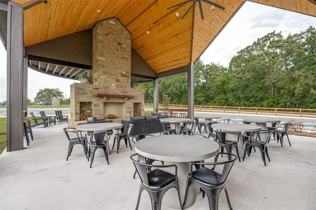 a bathroom with a tub sink and large window