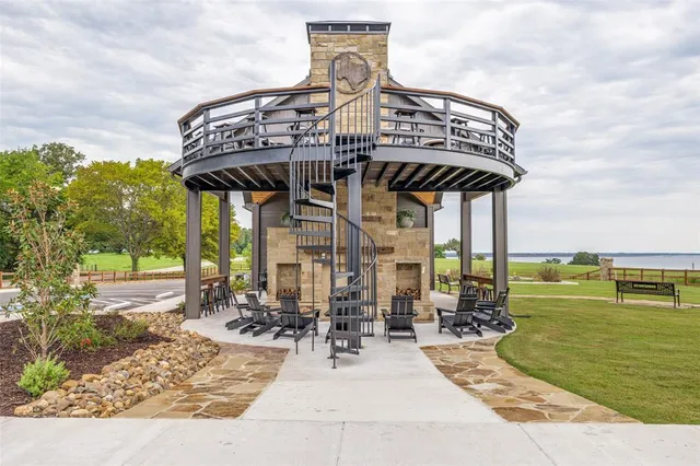 a view of a house with a big yard and sitting area