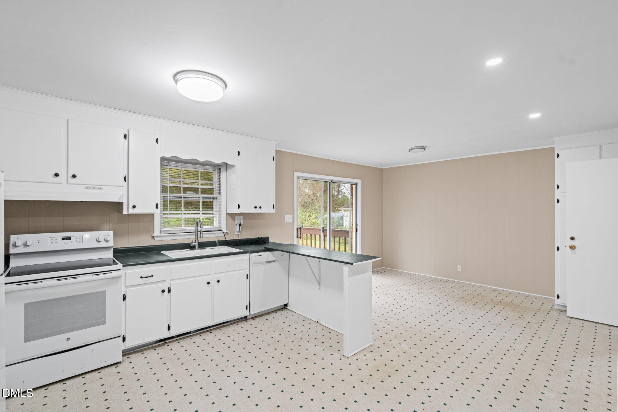 3712 Huntleigh Drive Raleigh, NC 27604 - Photo 11 of 36 a kitchen with granite countertop white cabinets and white appliances