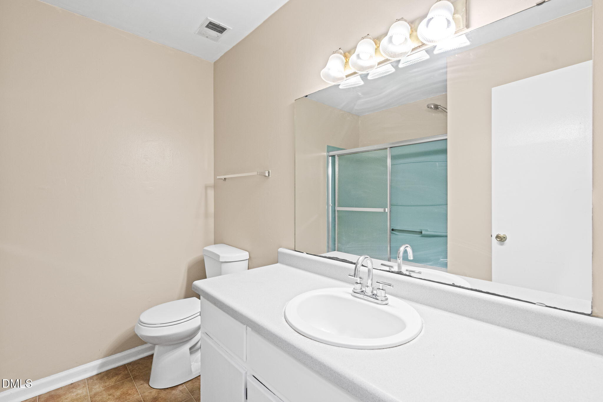 3712 Huntleigh Drive Raleigh, NC 27604 - Photo 28 of 36 a bathroom with a toilet a sink and mirror