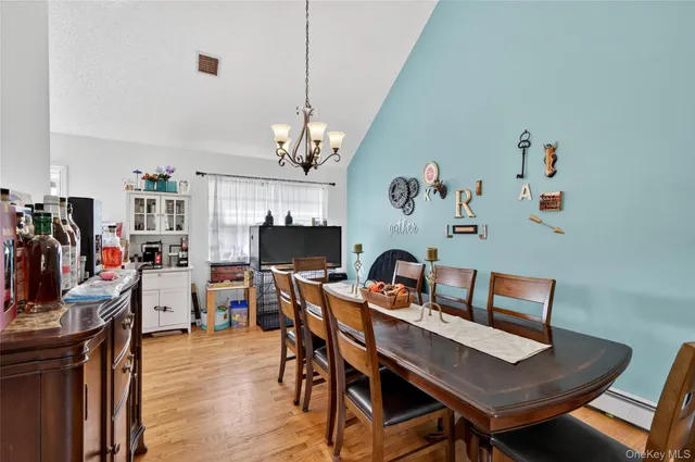 a view of a dining room with furniture and chandelier