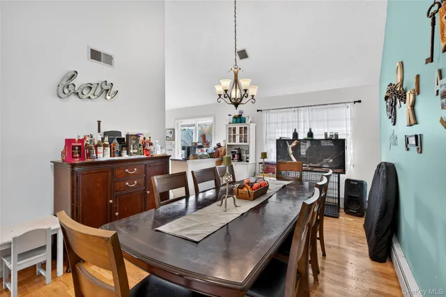 a view of a dining room with furniture and a chandelier
