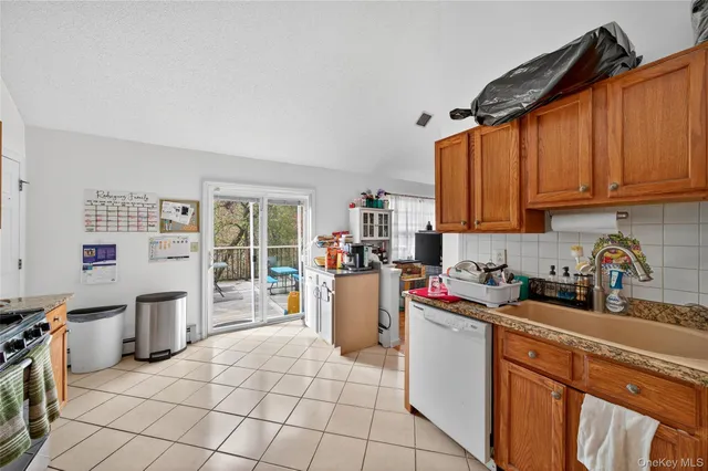 a kitchen with a sink a stove and cabinets