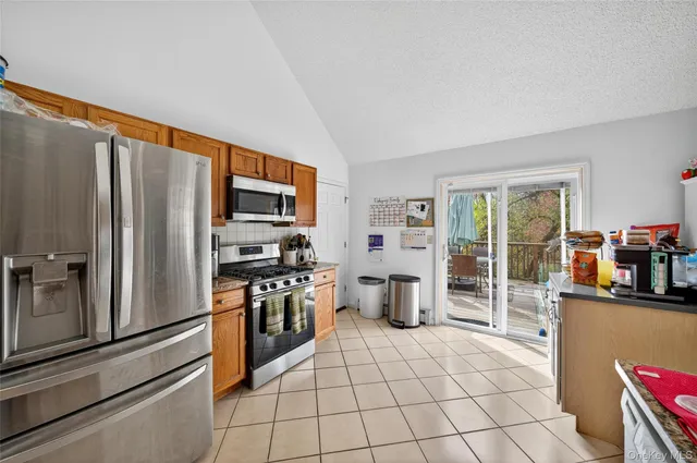 a kitchen with stainless steel appliances a refrigerator stove and sink
