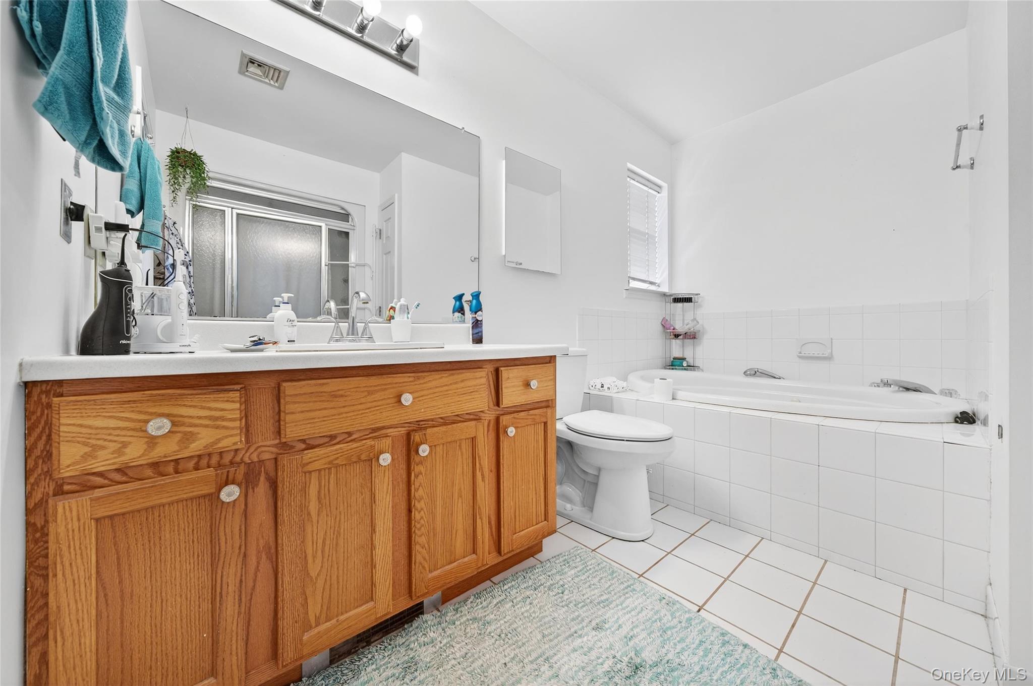 2 Berkeley Court Highland Mills, NY 10930 - Photo 22 of 44 a bathroom with a sink a toilet and shower