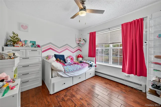 a view of a room with furniture and wooden floor