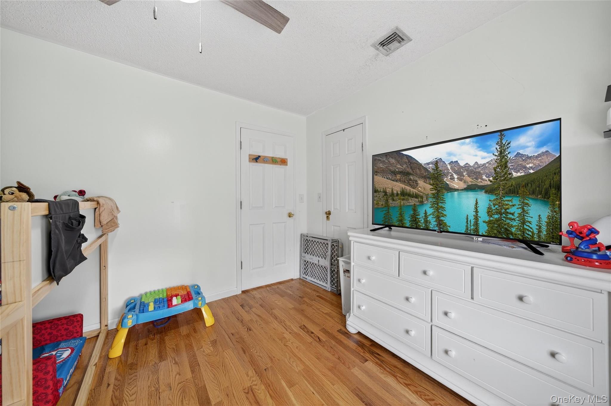 2 Berkeley Court Highland Mills, NY 10930 - Photo 27 of 44 a hallway with white cabinets and wooden floor