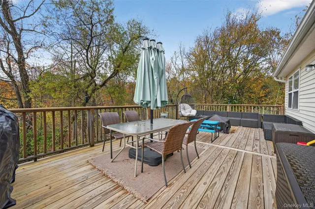 a view of a chairs and table on the deck